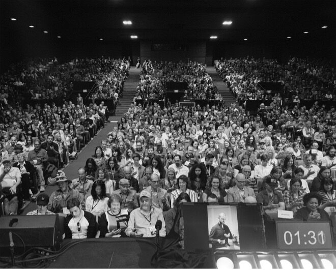 Black and White Image of People in an Audience with Imaginary Phones