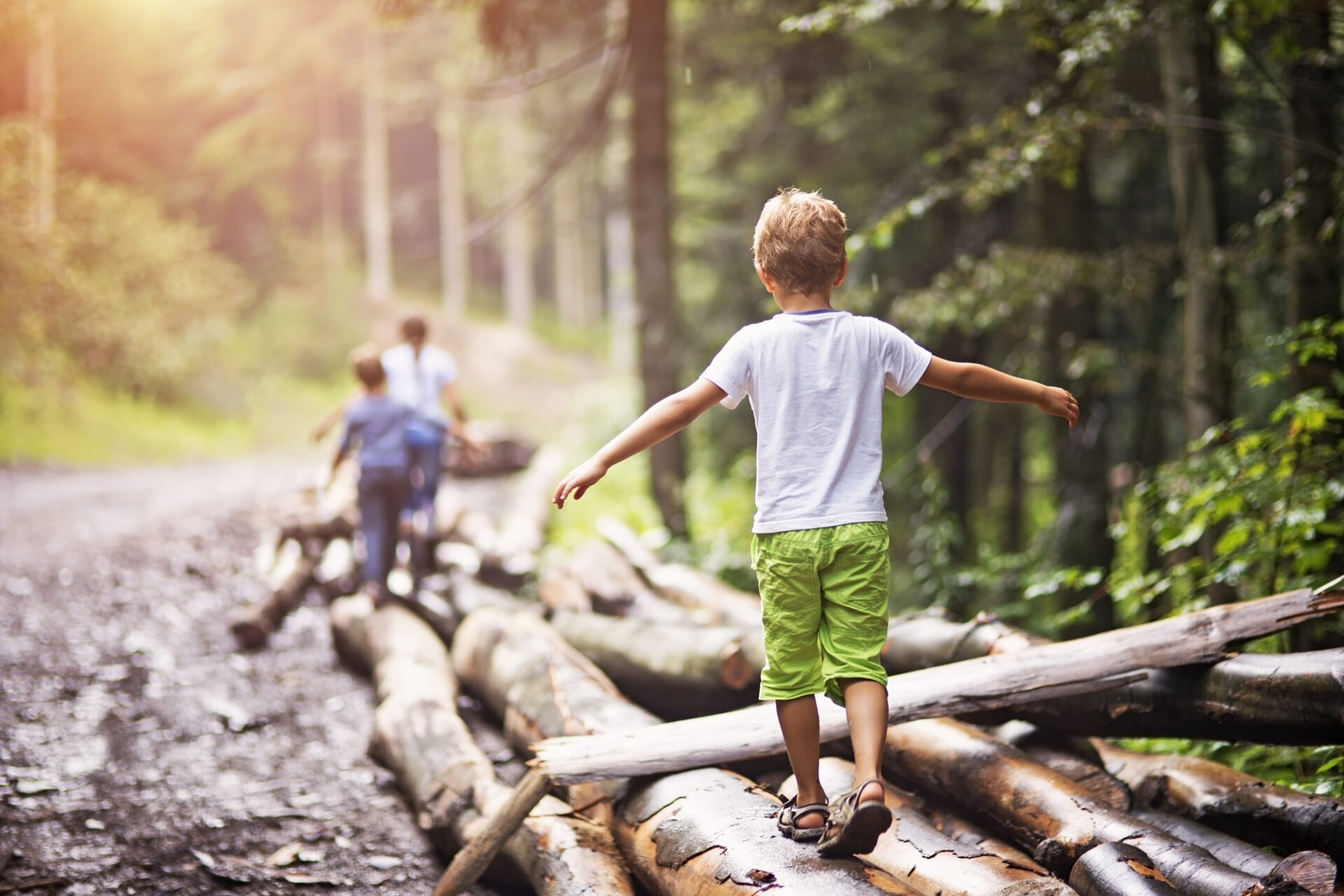 Children running on a path in the woods